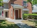Inviting brick townhome with a covered front porch and well-maintained walkway at 9404 S Vicksburg Park Ct, Charlotte, NC 28210