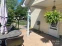 Inviting covered patio area with outdoor seating, perfect for enjoying the outdoors at 9612 Farmridge Ln, Matthews, NC 28105