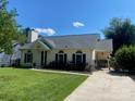 Beautiful one-story home with a well-kept lawn, complementing the appealing exterior at 9612 Farmridge Ln, Matthews, NC 28105