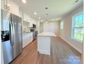Modern kitchen boasts stainless steel appliances, an island, and plenty of white cabinetry for ample storage at 111 W Perry St, Heath Springs, SC 29058