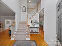 Grand foyer with hardwood floors, staircase and decorative rug, creating an inviting entry at 11917 Ulsten Ln, Huntersville, NC 28078