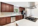 Bright kitchen featuring stainless steel appliances, white countertops, and dark wood cabinets at 1400 Matheson Ave, Charlotte, NC 28205