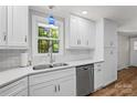 Bright kitchen features white cabinets, subway tile backsplash, stainless steel appliances, and quartz countertops at 144 Stoneybrook Rd, Salisbury, NC 28147