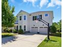 Charming two-story home boasting a basketball hoop, three-car garage and well-manicured lawn at 1478 Imperial Ct, York, SC 29745