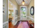 Inviting foyer with hardwood floors, trim detail, and a transom window above the front door at 1974 Links View Dr, Fort Mill, SC 29707
