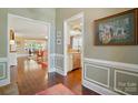 View from the hallway showcasing hardwood floors and trimmed doorways into multiple rooms at 1974 Links View Dr, Fort Mill, SC 29707