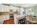 Bright kitchen with white cabinetry, granite countertops, a center island, and stainless steel appliances at 1974 Links View Dr, Fort Mill, SC 29707