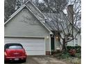 Charming exterior elevation view featuring a two-car garage and mature tree in the front yard at 20807 Willow Pond Rd, Cornelius, NC 28031
