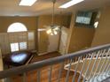 View from above of an open living space with skylights, hardwood floors, and a piano at 20807 Willow Pond Rd, Cornelius, NC 28031