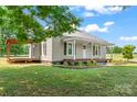 Beautiful home featuring a covered porch and deck, complemented by a lush green lawn at 233 Sellars Rd, Kings Mountain, NC 28086