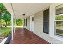 Covered front porch featuring painted wood floors, neutral siding, and black window shutters at 233 Sellars Rd, Kings Mountain, NC 28086