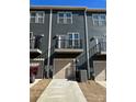 Rear exterior view showing garage and private balcony space, perfect for relaxing outdoors at 3007 Citizens Ln, Charlotte, NC 28205