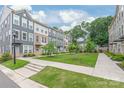 Exterior view of townhouses with well-manicured lawns and sidewalks, creating a welcoming community atmosphere at 3007 Citizens Ln, Charlotte, NC 28205