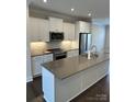 Modern kitchen featuring stainless steel appliances, gray countertops, and white cabinetry at 3007 Citizens Ln, Charlotte, NC 28205