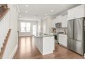 Bright, open-concept kitchen featuring a large island, stainless steel appliances, and hardwood floors at 3007 Citizens Ln, Charlotte, NC 28205