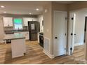 The kitchen features ample counter space, island, stainless steel appliances, and stylish cabinets at 32874 Old Salisbury Rd, Albemarle, NC 28001
