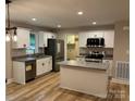 Bright kitchen featuring stainless appliances, white cabinets, and a functional island at 32874 Old Salisbury Rd, Albemarle, NC 28001