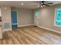 Inviting living room with wood-look floors, fresh paint, and a modern ceiling fan at 32874 Old Salisbury Rd, Albemarle, NC 28001