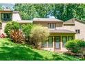 Private backyard with mature landscaping, a green lawn and convenient access to the home at 4025 Ivystone Ct, Charlotte, NC 28277