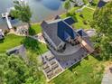 Aerial view of a stunning lakefront property with lush greenery and a private dock at 445 Sundown Rd, Mooresville, NC 28117