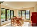 Bright dining room with large windows offering lake views and a vintage Coca-Cola refrigerator at 445 Sundown Rd, Mooresville, NC 28117
