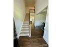 Inviting entryway featuring hardwood floors, a staircase, and views into the formal dining room at 5005 Blue Serenity Ct, Denver, NC 28037