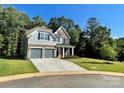 A charming two-story home with a lush lawn and inviting driveway at 5005 Blue Serenity Ct, Denver, NC 28037