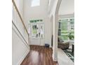 Bright and open foyer featuring hardwood floors, staircase, and ample natural light at 5021 Meadow Woods Dr, Lowell, NC 28098