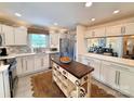 Well-lit kitchen with stainless steel appliances, center island, and white cabinets at 5033 Baylor Dr, Charlotte, NC 28210