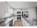 Bright kitchen with white cabinets, granite countertops, and stainless steel appliances at 571 Nesbe St # 2221, Lancaster, SC 29720