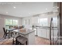 Stylish kitchen with an island, stainless steel appliances, and an adjacent dining area at 571 Nesbe St # 2221, Lancaster, SC 29720