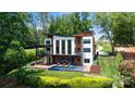 Beautiful backyard featuring an in-ground pool, patio, and lush landscaping, perfect for outdoor living at 5930 Midsomer Rd, Charlotte, NC 28214