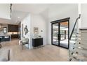 Bright foyer features a modern staircase, sleek black entry door, and stylish decor at 5930 Midsomer Rd, Charlotte, NC 28214