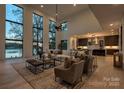 Bright living room with soaring windows, lake views, and open floor plan at 5930 Midsomer Rd, Charlotte, NC 28214