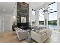 Bright and airy living room showcasing a modern fireplace, large windows, and comfortable seating at 5930 Midsomer Rd, Charlotte, NC 28214