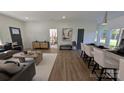 Bright living space showcasing an open layout, hardwood floors, modern furnishings, and bedroom view at 6386 Cathedral Dr, Granite Falls, NC 28601