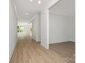 Spacious hallway with wood-look flooring, white walls, and ample natural light from the windows at 722 Lithia Inn Rd, Lincolnton, NC 28092
