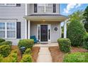 Inviting front porch with blue chair and decorative landscaping for added curb appeal at 7671 Bluff Point Ln, Denver, NC 28037