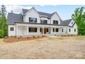 Elegant two-story home with a covered front porch, black window trim, and mature landscaping at 770 Highway 274 Rd, Clover, SC 29710