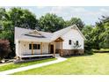 Inviting exterior showcasing a charming home with a covered porch and beautifully landscaped lawn at 8340 Brief Rd, Mint Hill, NC 28227