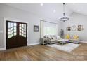 Bright living room with soaring ceilings, stylish chandelier, and lots of natural light at 8340 Brief Rd, Mint Hill, NC 28227