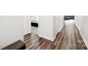 Hallway featuring neutral walls, wood flooring, and natural light that creates a welcoming atmosphere at 9525 Festival Way, Charlotte, NC 28215