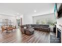 Open-concept living area featuring wood flooring, comfortable seating, and a dining area with lots of light at 9525 Festival Way, Charlotte, NC 28215