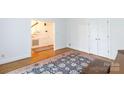Open hallway featuring hardwood floors, a staircase, and access to the home's interior at 9901 Pallisers Ter, Charlotte, NC 28210