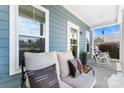 Inviting covered front porch with comfortable seating, decorative pillows, and a charming rocking chair at 1067 33Rd Avenue Ne Loop, Hickory, NC 28601
