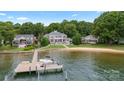 Aerial view of waterfront homes, a private dock and sandy beach on a sunny day at 123 Sailview Rd, Mooresville, NC 28117