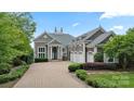 Beautiful stone home with a brick driveway, a 4-car garage, and professionally landscaped front yard at 123 Sailview Rd, Mooresville, NC 28117