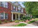 Charming townhouse with brick and siding, complemented by well-maintained landscaping and a inviting front porch at 12350 Swan Wings Pl, Huntersville, NC 28078