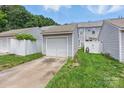 A single car garage with white siding sits at the end of a concrete driveway and green lawn at 12350 Swan Wings Pl, Huntersville, NC 28078