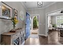 Welcoming entryway with a blue front door, hardwood floors, elegant decor, and access to the living spaces at 17112 Courtside Landing Dr, Cornelius, NC 28031